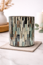 Distressed mosaic candle holder on marble