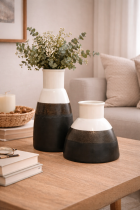 Modern vases with greenery and books