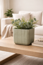 Sage green planter on oak table