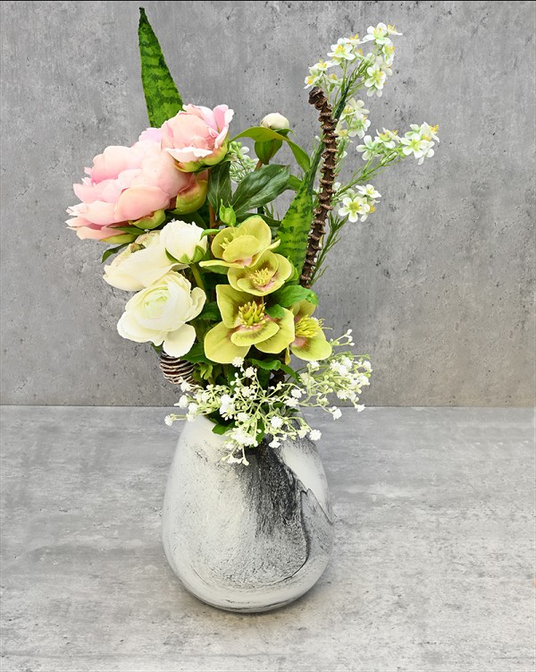 Black swirl glass vase with Peonies, Ranunculus and Hellebores