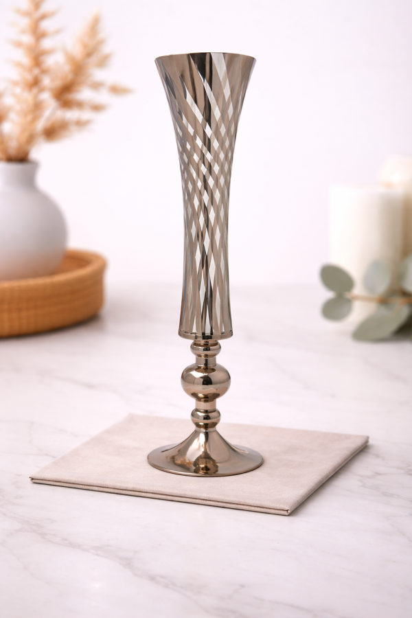 Elegant metallic vase on marble countertop