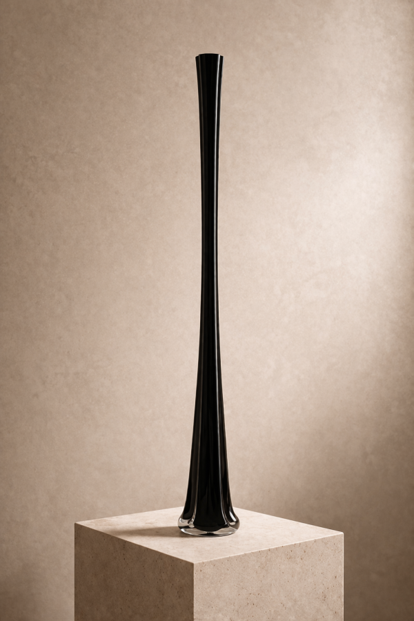 Minimalist black vase on stone plinth